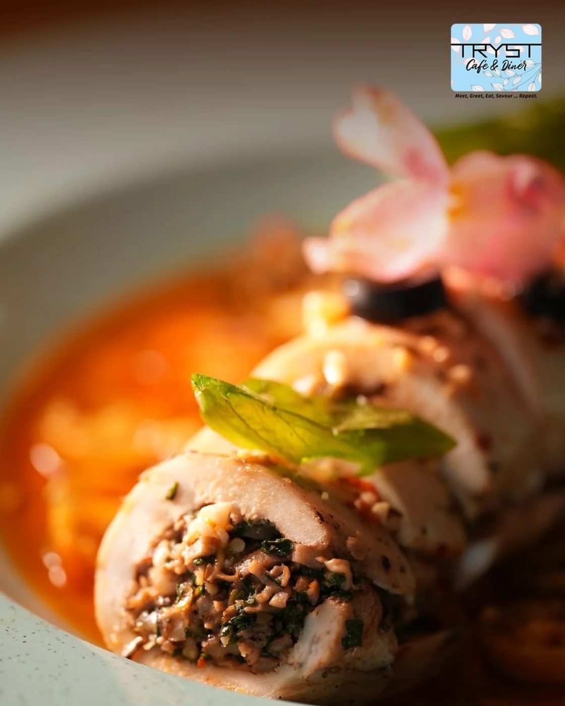 Chicken roulade with spinach and mushroom in a light tomato sauce